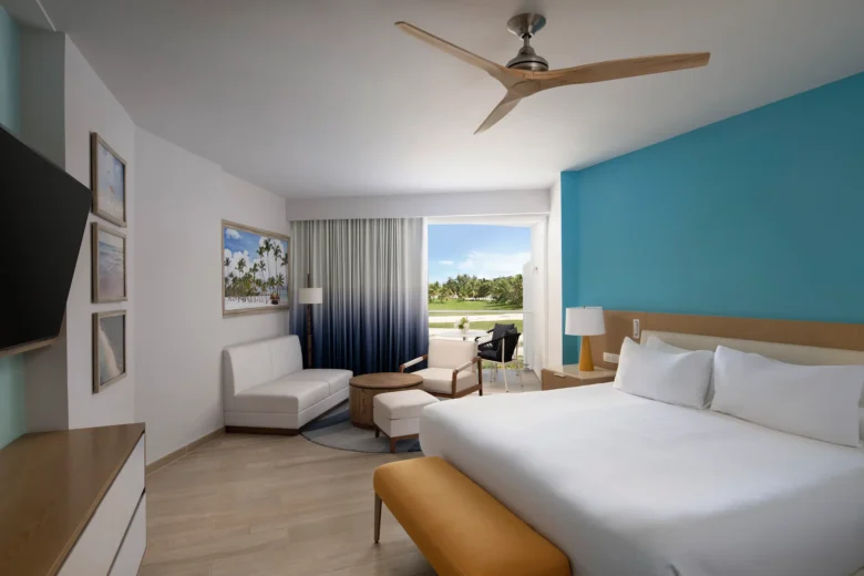 Deluxe Ocean View room with king bed, sitting area, and private balcony at Dreams Cap Cana Resort & Spa.