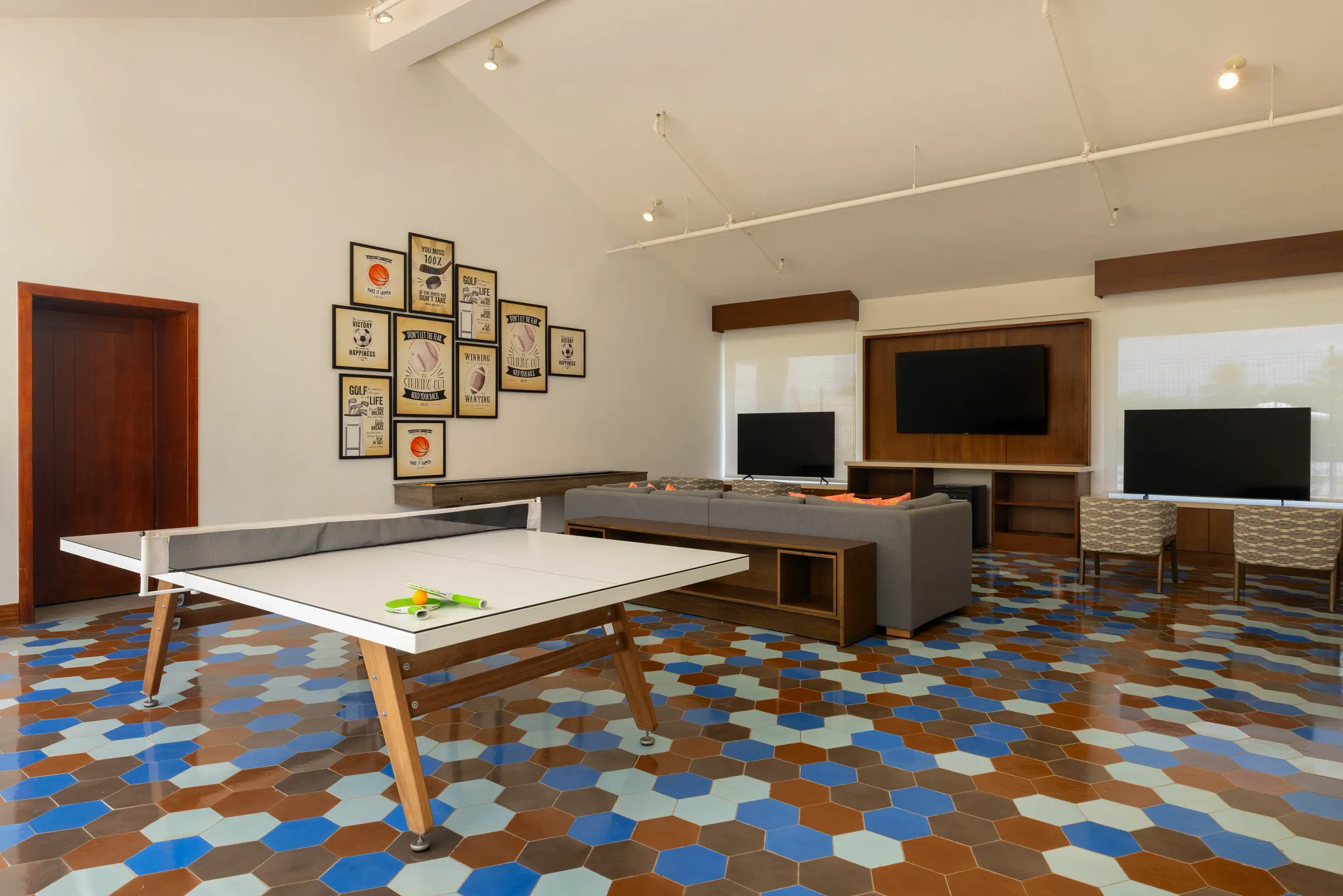 Indoor teen lounge with ping pong table and seating area at Dreams Cap Cana Resort & Spa Core Zone.