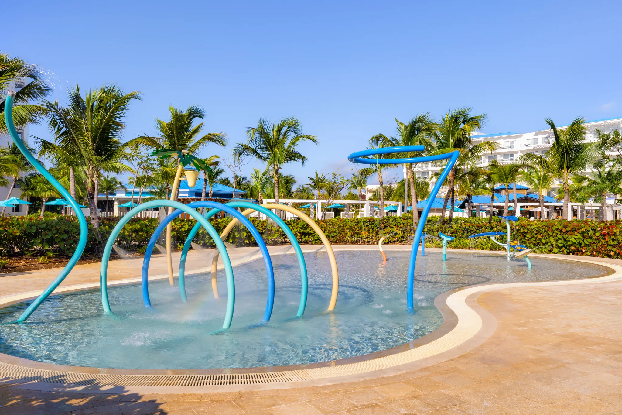 Kids splash pad with water features and colorful sprinklers at Dreams Cap Cana Resort & Spa.