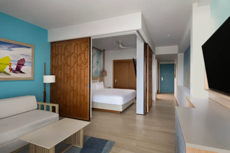 Junior Suite with sofa bed, king bed, and separate living area at Dreams Cap Cana Resort & Spa.