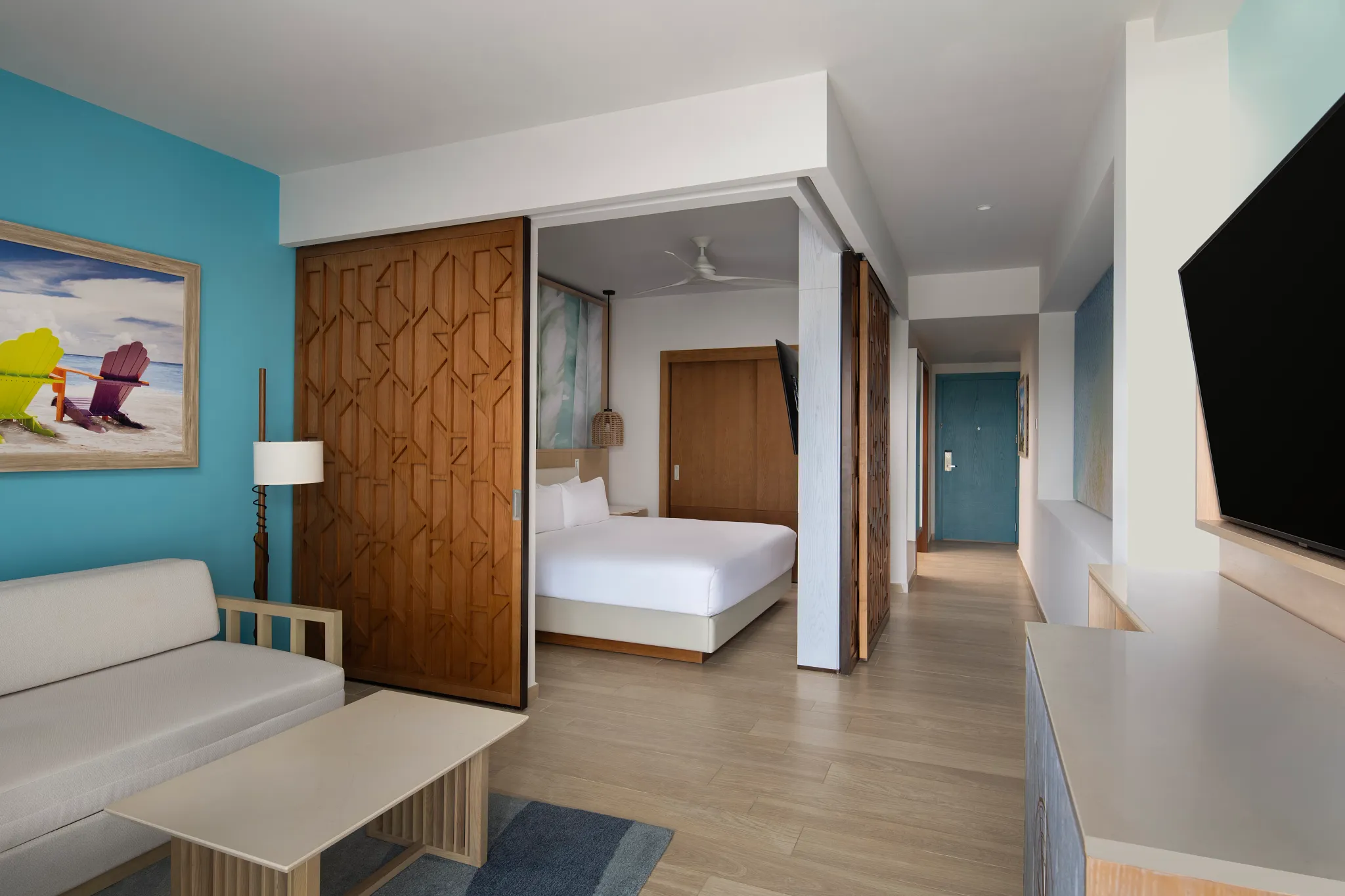 Junior Suite with sofa bed, king bed, and separate living area at Dreams Cap Cana Resort & Spa.