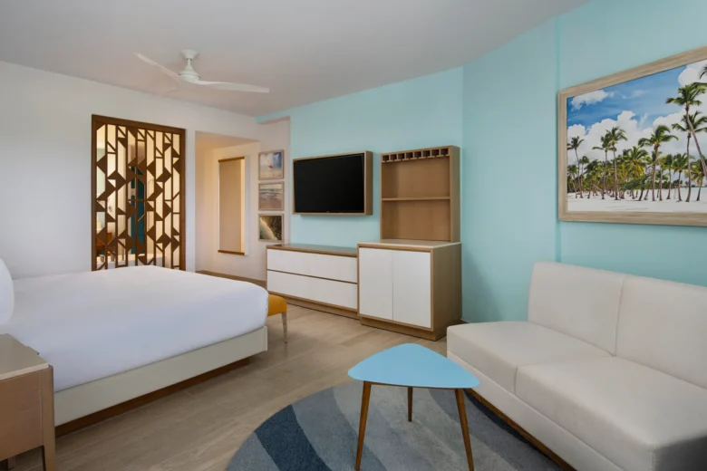 Preferred Club Deluxe Swim-Out room with king bed and modern seating area at Dreams Cap Cana Resort & Spa.