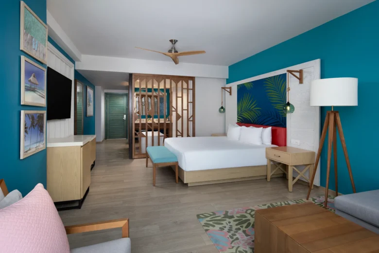 Preferred Club Junior Suite Swim Out King with sofa bed living area and king bed at Dreams Cap Cana.